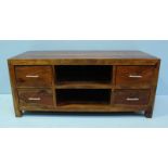 A modern teak television stand, the front with two open storage compartments flanked on either