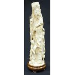A Qing Dynasty carved Chinese ivory figure of Fuxing modelled wearing robes and holding a Ruyi