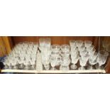 A large collection of drinking glasses most of which made by Stuart, including Sherry, Whisky,