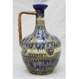 A Doulton Lambeth stoneware pottery ewer of ovoid form with tapered cylindrical neck and flared rim,