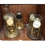 Five various brass anniversary clocks, all with glass domes.