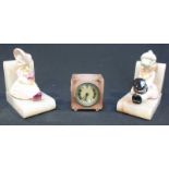 A pair of Alabaster Bookends, each mounted with a Porcelain figure, one being a girl, the other a
