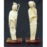 A pair of Qing Dynasty Chinese carved Ivory figures of Immortals, one carved as Lan Caihe holding