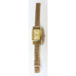 A Ladies 9ct Gold cocktail watch of rectangular form, the Arabic dial with "DOT" stamped to top,