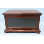 A late 19th/early 20th century mahogany tabletop bookcase, with shaped cornice above a hinged,