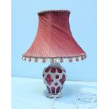 A 19th century overlaid, opaque ruby glass vase, converted to an electric lamp, the handmade