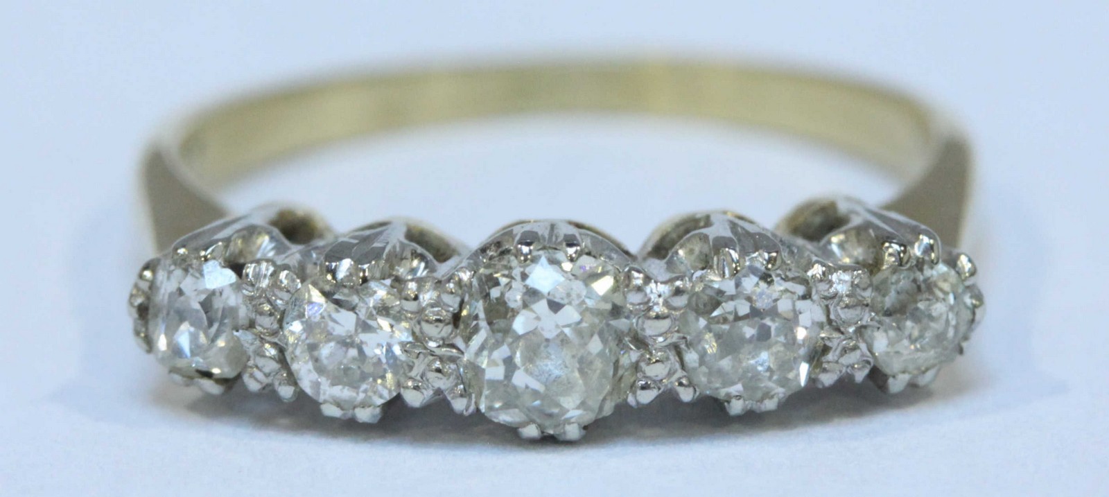 An 18ct gold five stone diamond ring, claw-set with four graduated Victorian-cut diamonds and one