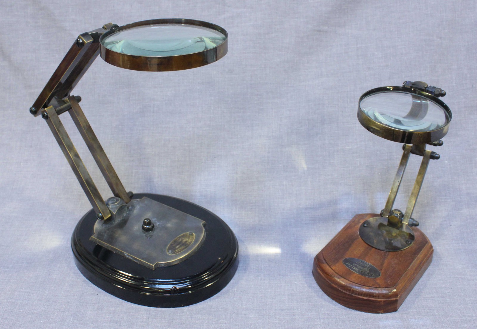 Two Articulated magnifying glasses by Watts and Sons Ltd, both with plagues reading "London 1814",