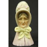 A 19th century Royal Worcester Porcelain candle snuffer modelled as an old lady wearing a white