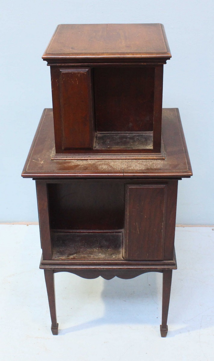 An Edwardian walnut graduated two-tier bookcase, with shaped apron and raised on tapering, square