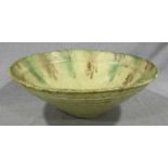 An 18th century tin-glazed earthenware bowl, with green and brown decoration to a cream ground,