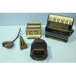A group of three accordions of varying style, including one by Maugein and one with ornate floral