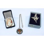 A Silver and pearl brooch shaped as a floral design, together with a Cameo brooch and matching