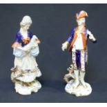 A Pair of German Unter Weiss Bach Porcelain figures, one depicting a lady holding a lamb, the