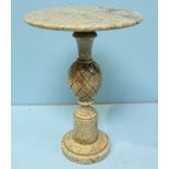 An Italian alabaster table with circular top raised on an ornately shaped and carved support to a