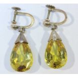 A pair of early 20th century yellow-metal mounted citrine drop earrings, the pear-shaped faceted