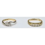 An 18ct yellow gold and platinum two stone illusion set crossover design diamond ring, together with