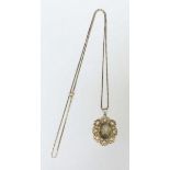 A 9ct gold necklace with ornate hanging pendant decorated with a large centrally set quartz and four