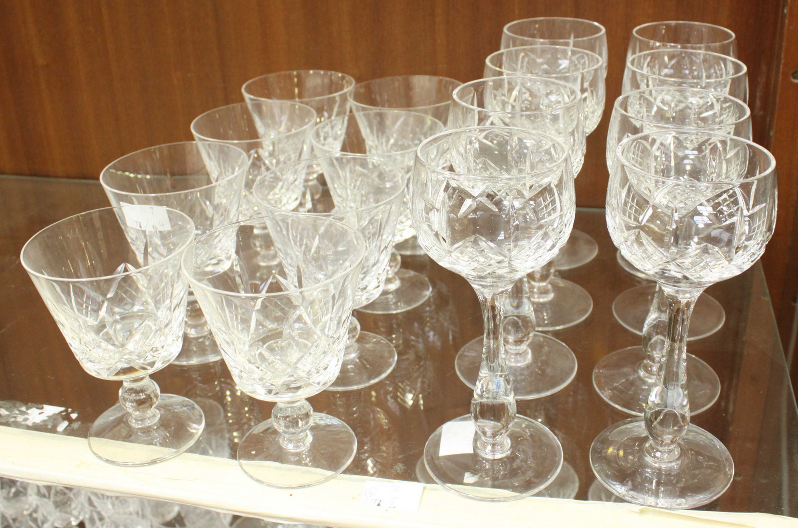 Sixteen Stuart drinking glasses, consisting 8 Hock glasses and 8 Wine glasses, all stamped to