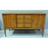 A 1960's/70's walnut sideboard by 'Gordon Russell,' comprising of three central graduated drawers