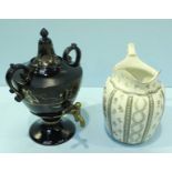 A Victorian ceramic Samovar tea urn with brass spigot and two handles, black ground with gilded leaf