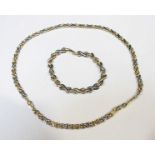 A 9ct bi-colour gold figure-of-eight link necklace and matching bracelet, 18.46 grams