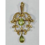 A 15ct gold filigree pendant set with peridot and seed pearls.