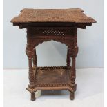 A 19th Century Anglo-Indian hardwood occasional table, profusely carved with lattice and foliate