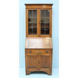 A 20th century Oak Bureau bookcase, the base comprising a cupboard, single drawer and opening