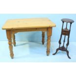 A pine dining table on shaped and turned supports, together with an oak wig stand with circular top,