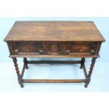 A 1930's oak side table with single, long frieze drawer and brass pulls, raised on barley twist