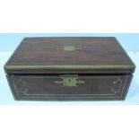 A 19th Century mahogany brass bound travelling writing slope, the hinged top opening to reveal a