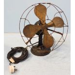 A vintage electric fan with bent wire cage and with plaque reading 'Veritys ltd.' 41cm high.