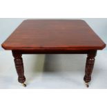 A late Victorian mahogany extending dining table, raised on turned supports to castors. 180cm