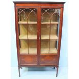 An Edwardian mahogany and inlaid two door display cabinet, with two Gothic tracery, glazed doors,