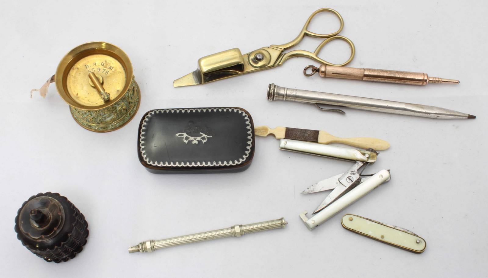 An assortment of various collectables including a papier mache snuffbox, a brass tape measure and