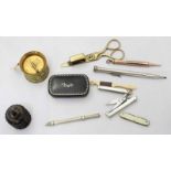 An assortment of various collectables including a papier mache snuffbox, a brass tape measure and