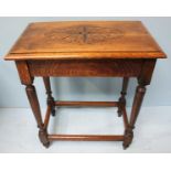 An Edwardian Oak occasional table, the top decorated with a floral design, on turned supports,