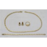 A 14ct yellow gold jewellery set with Greek key decoration, including a necklace, bracelet, ring and