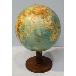 A Columbus globe supported on a stained beech wood swivelling stand. 50cm high.