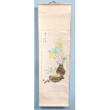 A box containing four various Oriental watercolours, presented as scrolls and depicting floral still