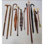 Twelve various walking canes and umbrellas, some with calved handles etc.