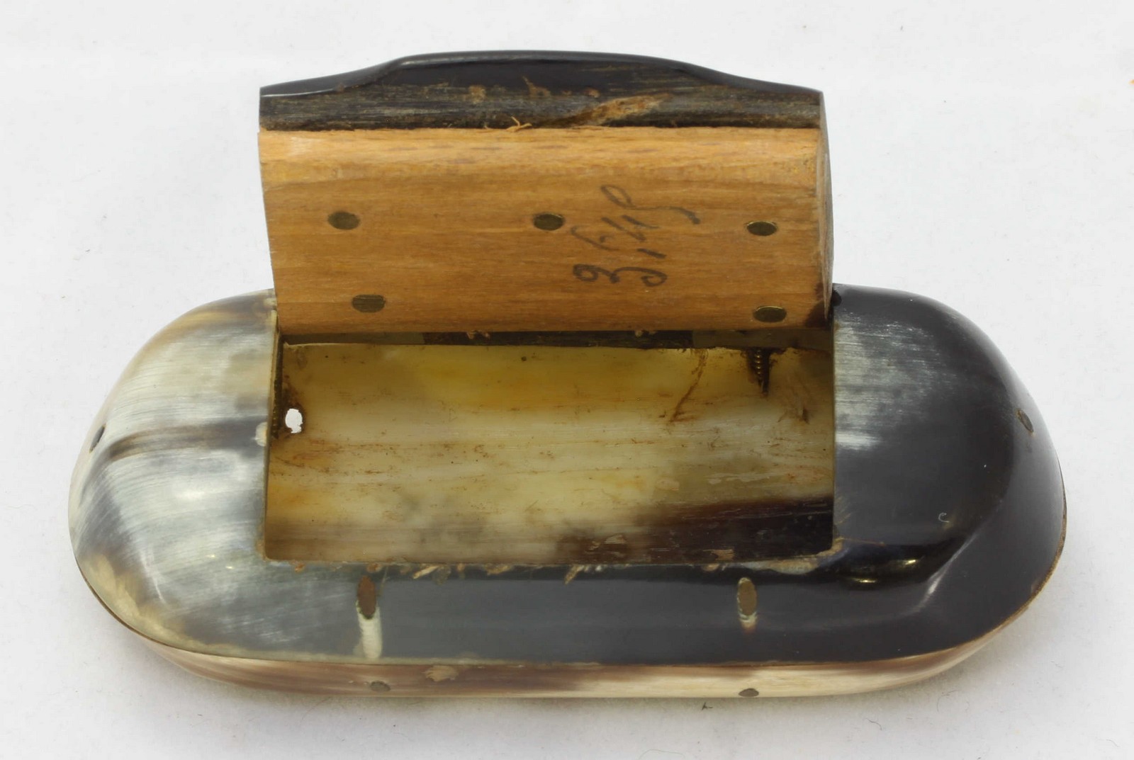 A two-tone horn snuffbox of oval form, together with a large 19th century family bible.