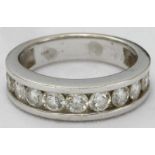 An 18k white gold and diamond ring, plain band channel-set with eleven RBC diamonds estimated 1.5