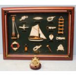 A modern glass fronted framed Sailing display showing various sailing related items, including