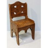 A late Victorian walnut hall chair, profusely decorated with foliate decoration, 95cm high