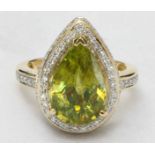 An 18K yellow gold, Sphene and diamond ring, claw-set a large pendeloque-cut sphene, measuring