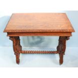 A stained oak side table with carved edges and raised on lyre supports. 76cm wide.