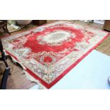 A large modern, tufted rug in the 18th century French style, with floral, central medallion to a