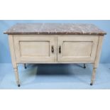 A painted French wash stand, with marble top above to panelled cupboard doors enclosing storage